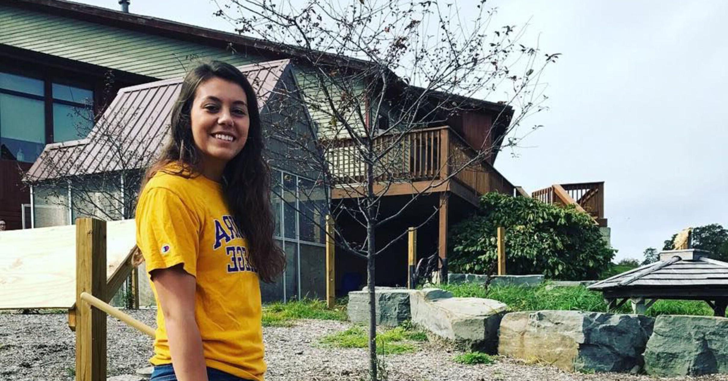 A student st和s in front of the Tanglewood Nature Center